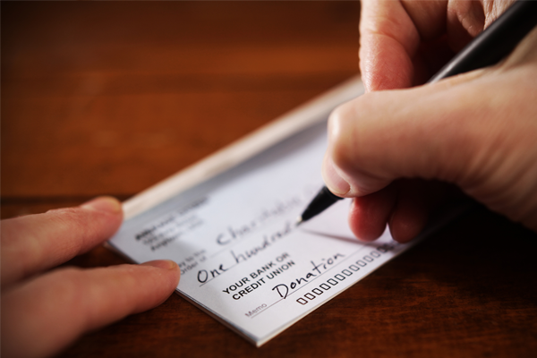 closeup of person writing a check